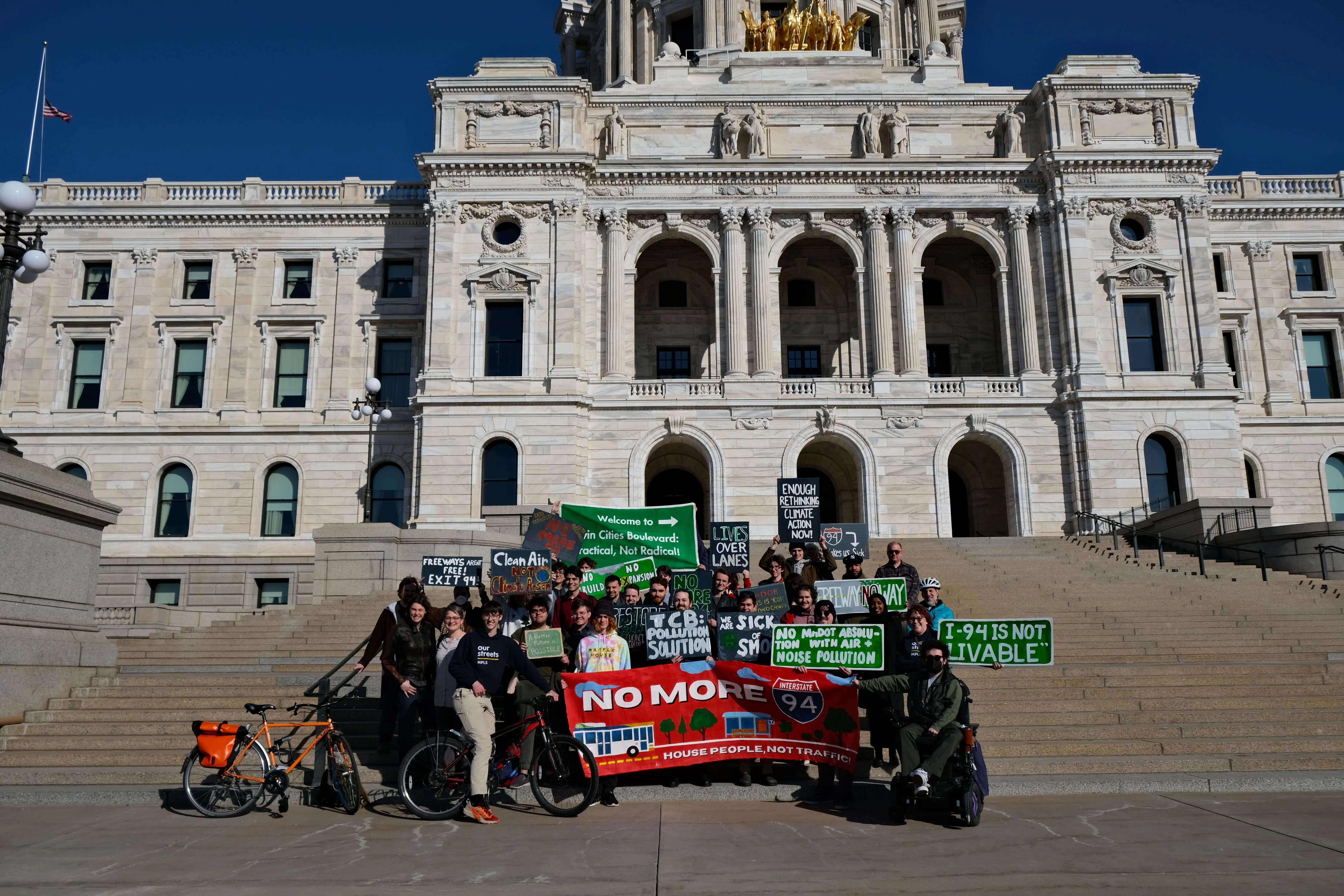 Twin Cities Boulevard supporters with painted signs in front of the Minnesota State Capitol