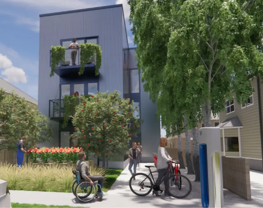 A developer's rendering of the new Firefly Apartments complex. A three story rectangular building with metal siding, large windows, and metal balconies. Two apple trees, orange lilies, tall grasses, and a small lawn are in front of the building. To the side of the building, large birch trees line a shaded concrete walkway to the building. A person with short hair and brown skin stands on the top balcony. A person with shoulder length hair and brown skin is on the second balcony. In front of the building, a person with short hair and white skin wearing overalls tends to the plants. A person with short hair in a wheelchair rolls on the sidewalk toward the building. A person with shoulder-length light brown hair rolls their bike in front of the building. Two people walk toward the camera away from the building. A blue sky is in the background. An adjacent building with tan siding can be seen on the right edge of the frame, behind the line of birch trees.