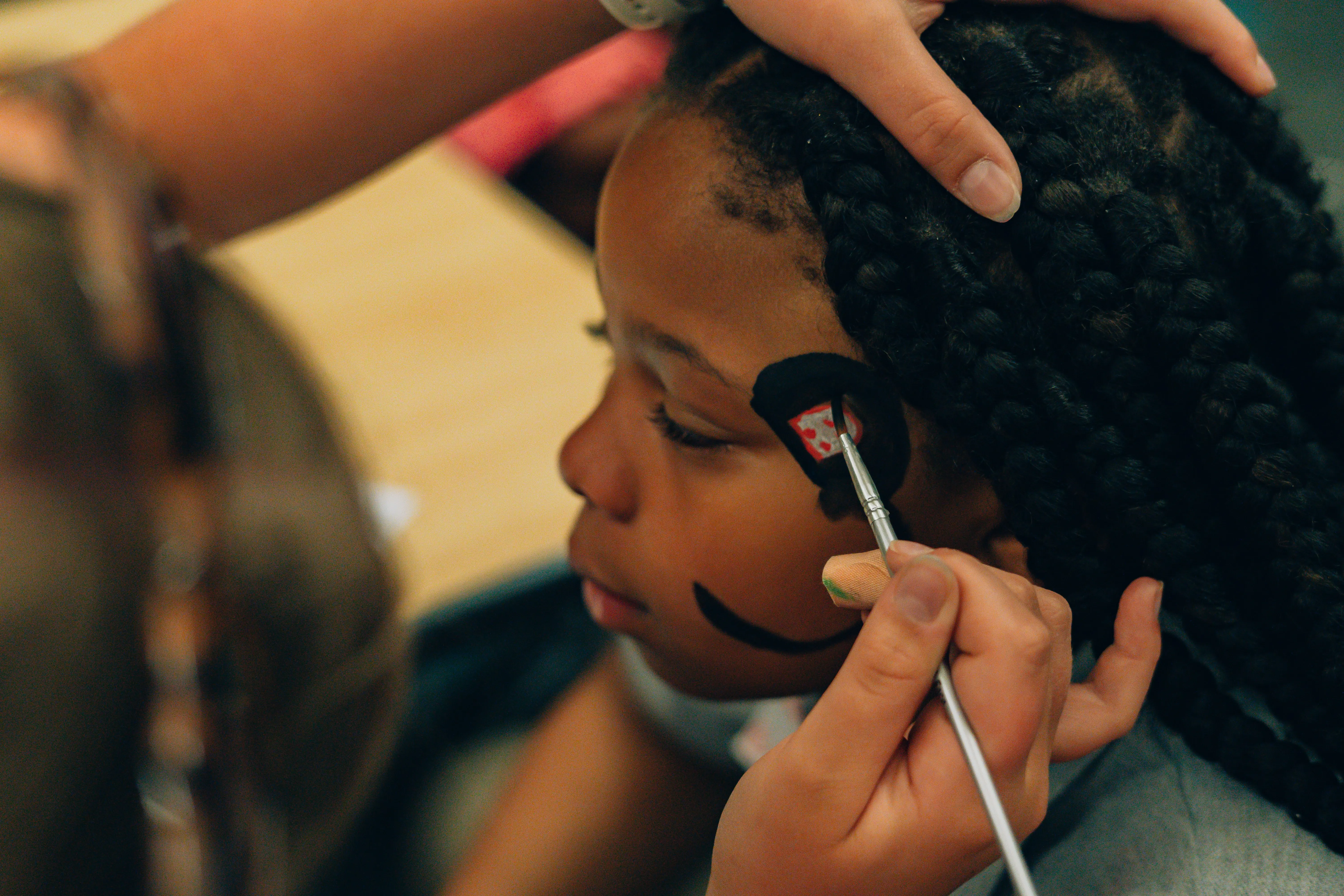 close up of kid getting their face painted