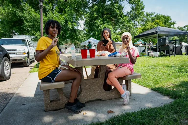 people smiling at a picnic table