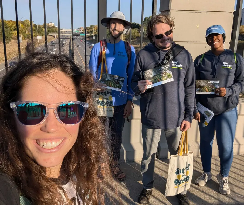 selfie of canvassers smiling on the 94 bridge with twin cities boulevard materials