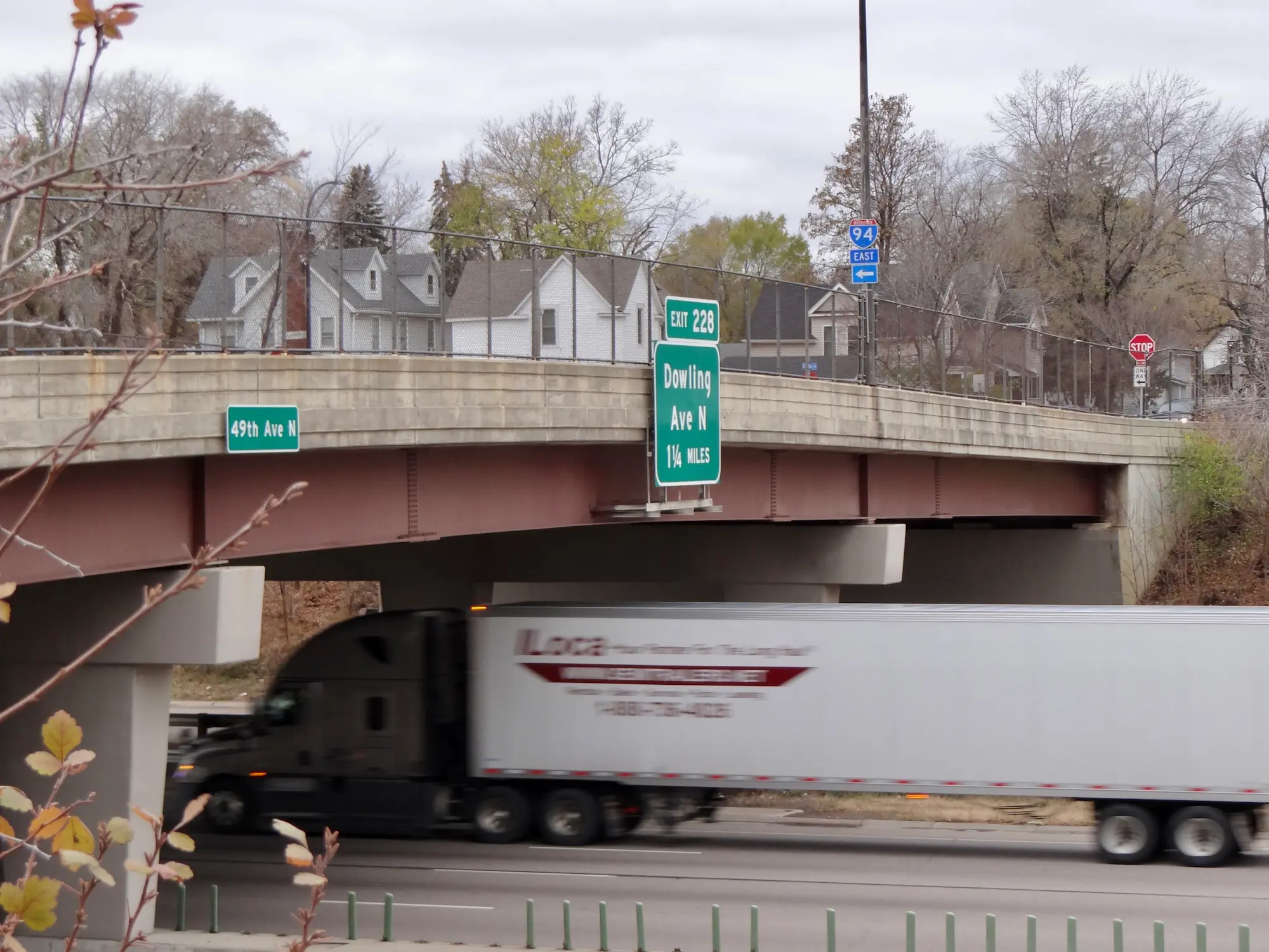 truck going under a highway bridge